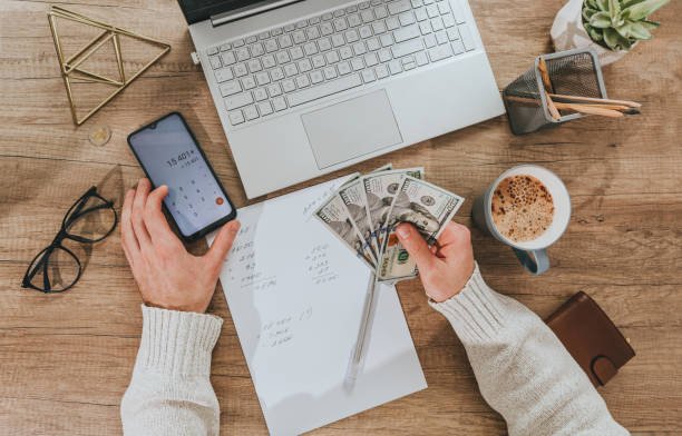 person using 50 30 20 budget rule in real life planning monthly expenses on laptop